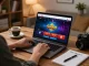 Engaging gameplay on Sin88 online casino app displayed on laptop, showcasing interactive interface and warm home atmosphere.